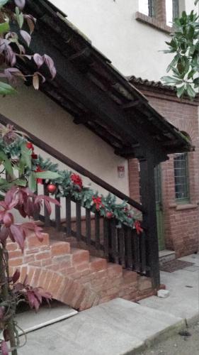 a black fence with flowers on it in front of a house at B&B San Martino in Mede