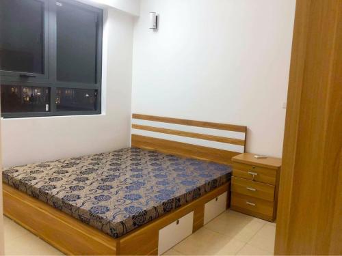 a small bedroom with a bed and a window at Ha Long Homestay in Ha Long