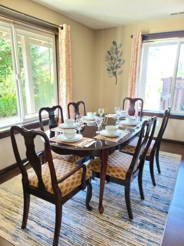 a dining room with a wooden table and chairs at Spacious and peaceful 4 bedroom home in Everett