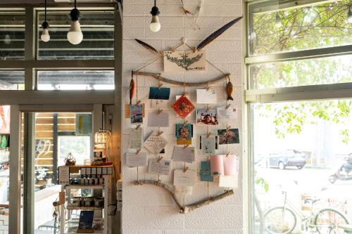 a wall with a bulletin board in a store at South Talk B&B in Hengchun