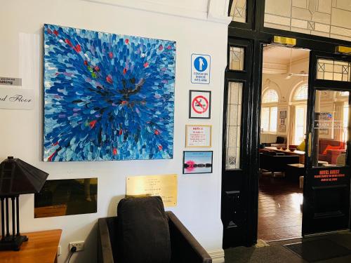 a large painting on a wall with a couch at Wallaby Backpackers Hostel Perth - note - Valid passport required to check in - in Perth