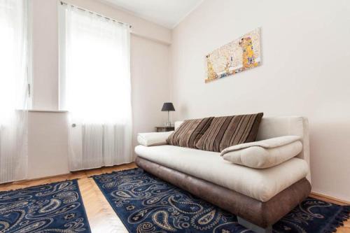 a living room with a couch and a rug at Home Away Apartment in Budapest