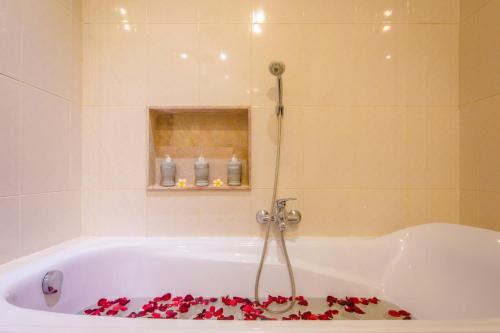 a bathroom with a tub with roses on the floor at Villa Tepi Sungai - Luxury 6-BR villa, sleeps 14, 15m pool in Seminyak in Legian