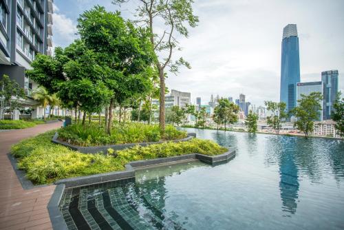 a river in a city with tall buildings at Continew Residence KL CoBNB in Kuala Lumpur