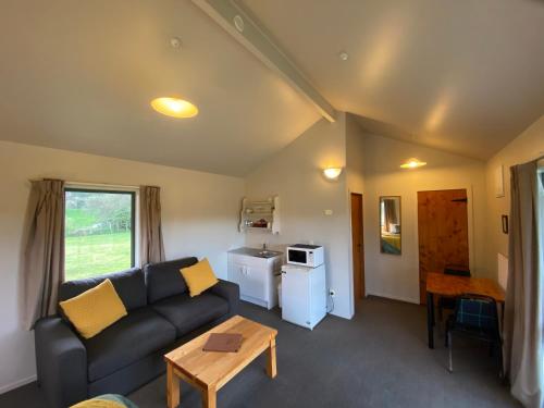 a living room with a couch and a table at Makoura Lodge in Apiti