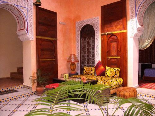 a living room with a couch and a table at Riad Idrissi in Meknès