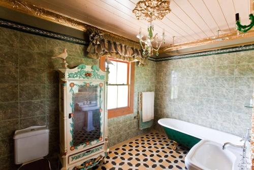 a bathroom with a bath tub and a sink at Tracy's Boutique B&B Farmstay in Wellsford