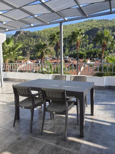 a table and two chairs on a patio at Bluberry Central Fethiye's apartment in Fethiye