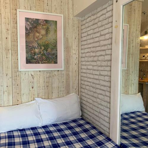 a room with a bed and a painting on the wall at Tagaytay Prime Residences with FREE wifi netflix light cooking viewdeck in Tagaytay