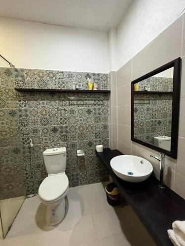 a bathroom with a toilet and a sink at Kha Hostel in Hue
