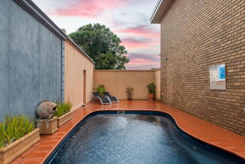 a swimming pool in the backyard of a house at The Cosy Room at Arlingtons in Portarlington