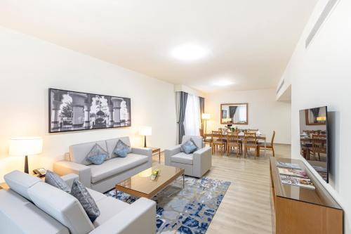 a living room with a couch and a table at Golden Sands Suites in Dubai