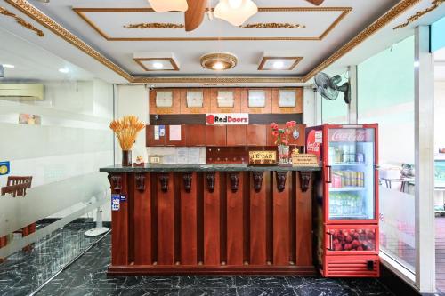 a restaurant with a red counter and a refrigerator at Quang Hoa Airport Hotel in Ho Chi Minh City