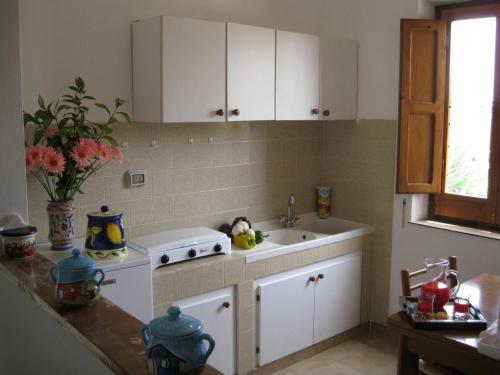 a kitchen with a sink and a stove at Casale Due Palme in Favignana