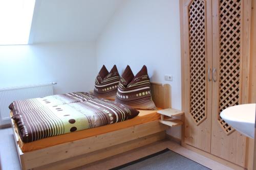 a bed with pillows on it in a room at Apartment Graber in Krimml