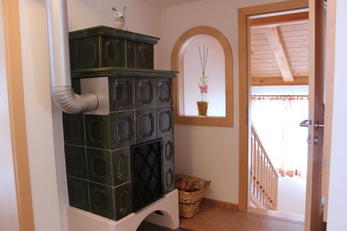 a living room with a large green cabinet and a mirror at Apartment Graber in Krimml