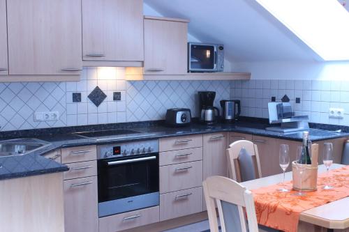 a kitchen with a stove and a table in it at Apartment Graber in Krimml