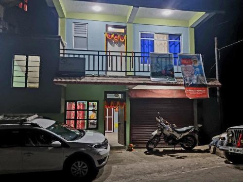 a motorcycle parked in front of a house at Neoravalley Homestay, Lava in Rishop
