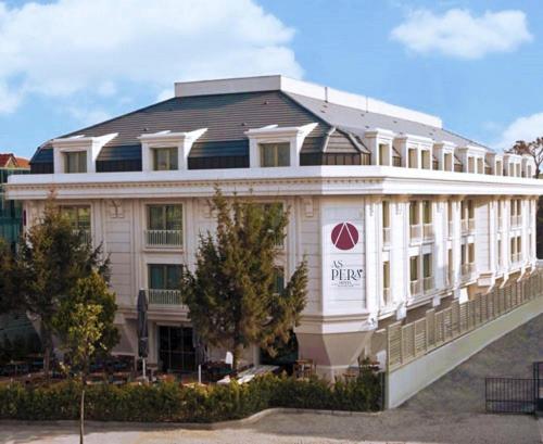 a large white building with a sign on it at Aspera Hotel Altunizade in Istanbul