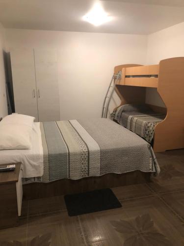 a small bedroom with a bed and a mirror at Apartments Tonka in Zadar