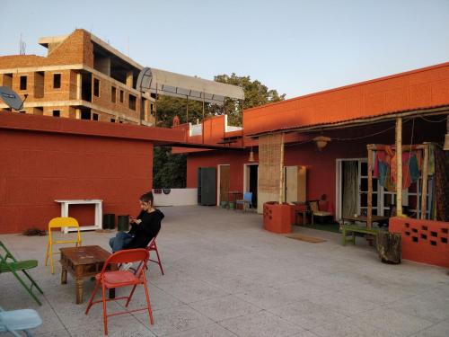 a woman sitting on a chair on a building at Home of the world in Jaipur