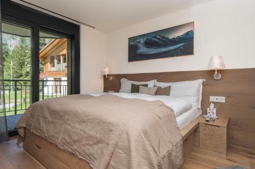 a bedroom with a large bed and a large window at Apartment in Chalet Pizzo Fiamma in Zermatt