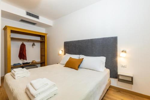 a bedroom with a large bed with two towels on it at Monte Forru in Baunei