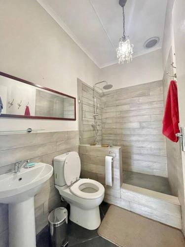 a bathroom with a white toilet and a sink at Living The Breede - Inhoek Farm Farmhouse in Malgas