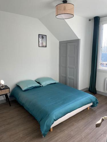 une chambre avec un grand lit avec une couverture bleue dans l'établissement T2 4 pers face gare SNCF Appart Hotel le Cygne 5, à Bourges