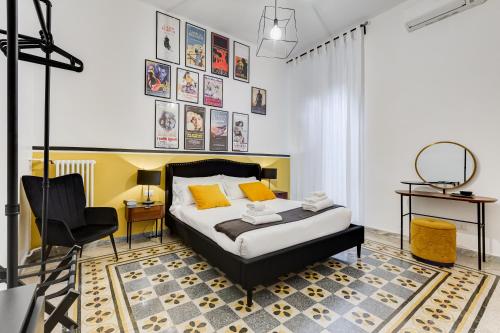 a bedroom with a bed and a chair at BDC - Residenza Valadier 3-Bdr and 3 bathrooms apt in Rome