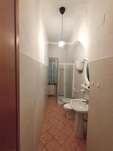 a bathroom with two toilets and a sink at le lanterne in Foligno