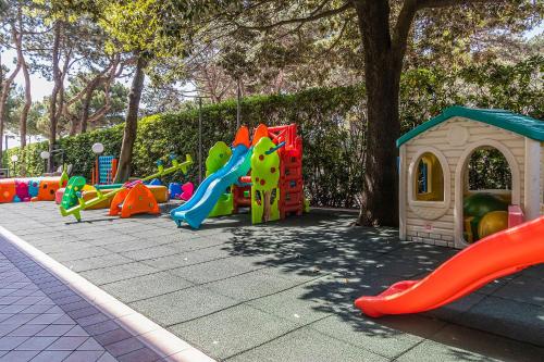 a playground with a bunch of play equipment at Hotel American in Lignano Sabbiadoro