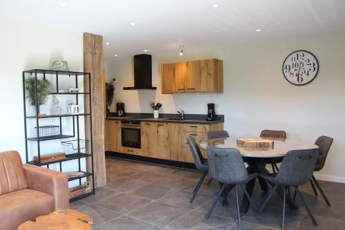 a kitchen and dining room with a table and chairs at Grindweg 4C in Westkapelle