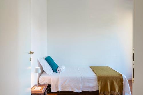 ein Schlafzimmer mit einem Bett mit einem blauen Kissen in der Unterkunft QUIET PLACE close to city center in Desenzano del Garda