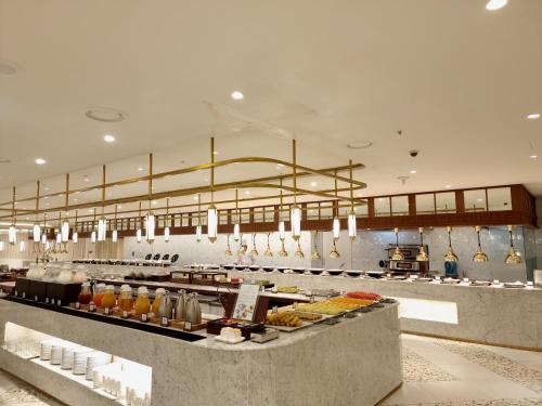 a large kitchen with a lot of food at Ibis Ambassador Suwon in Suwon