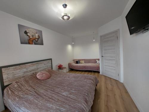 a bedroom with a large bed in a room at центр елітновобуд Яровиця 11 in Lutsk