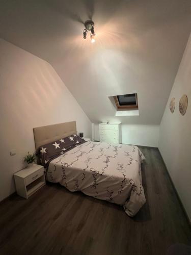 a bedroom with a large bed in a attic at La Perla del Pirineo in Jaca