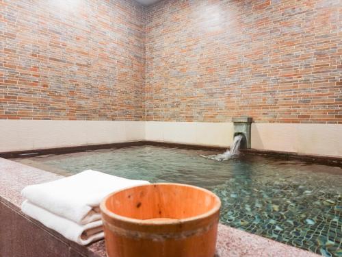 a large pool of water in a brick wall at Ibis Ambassador Suwon in Suwon