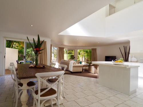 a kitchen and living room with a table and chairs at Beachfront Retreat - Ducted Air - Free Wifi in Coffs Harbour