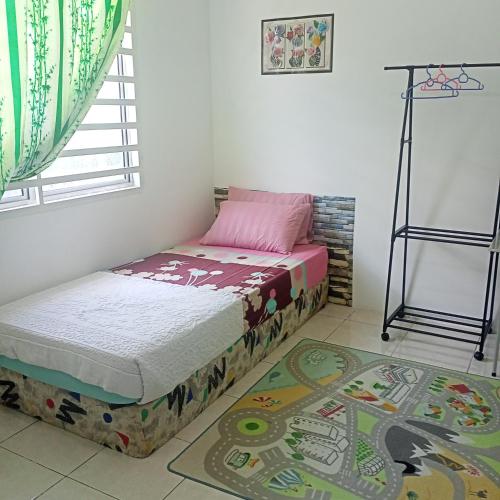 a small bedroom with a bed and a window at Alif Homestay Changlun in Changlun