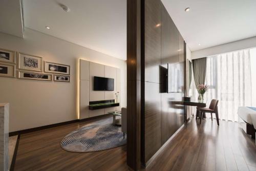 a hotel room with a bed and a desk and a room at Queen Ann Nha Trang Hotel in Nha Trang