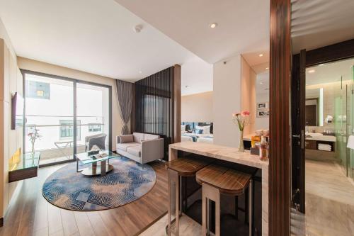 a living room with a table and a couch at Queen Ann Nha Trang Hotel in Nha Trang