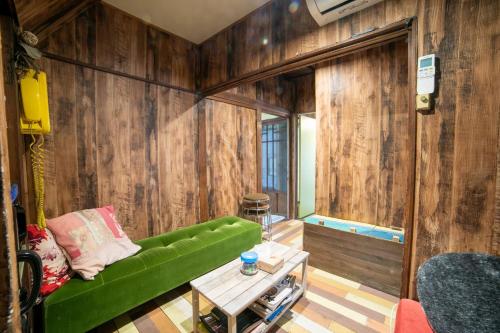 a living room with a green couch and a table at Villa Sacra in Kamakura