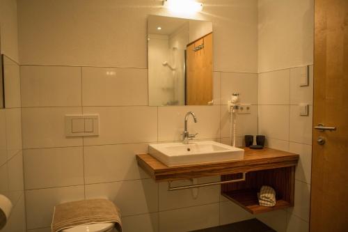 a bathroom with a sink and a mirror at Apart Sportiva in Klösterle am Arlberg