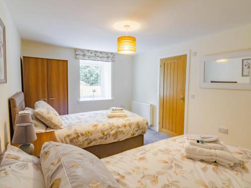 a bedroom with two beds and a window at Easter Caiplich - Uk30263 in Cray