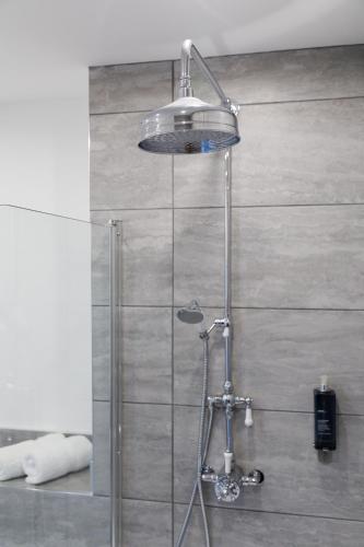 a shower with a glass door in a bathroom at 4 Canon Lane in Chichester