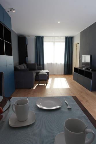 a living room with a table with two cups on it at Chiemsee Apartments in Altenmarkt an der Alz