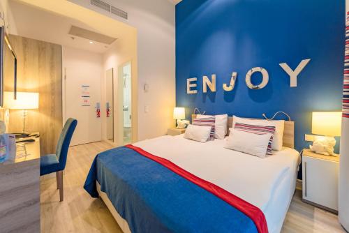 a hotel room with a bed and a sign on the wall at Estilo Fashion Hotel Budapest in Budapest