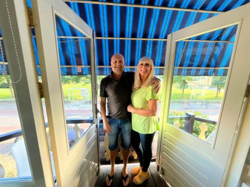 a man and a woman standing in a doorway at B&B de Zandtaart in Egmond aan Zee