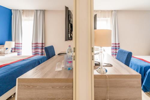 a hotel room with a desk and a bed and a bedroom at Estilo Fashion Hotel Budapest in Budapest